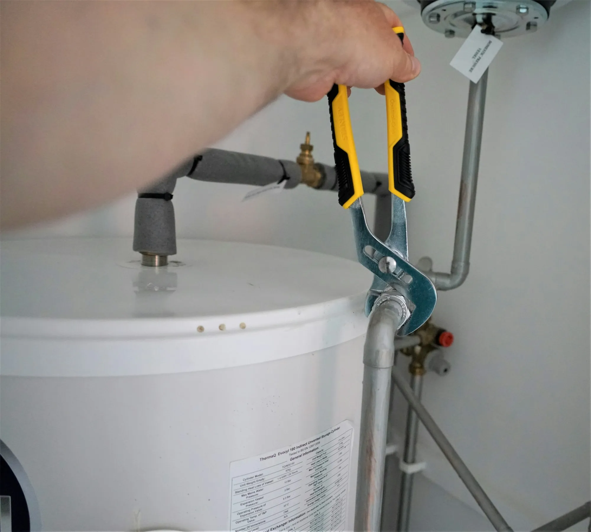 Wrench tightening a fitting on a water heater